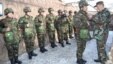 Azerbaijani President Ilham Aliyev (right) awards soldiers serving in the Geranboy district last month.