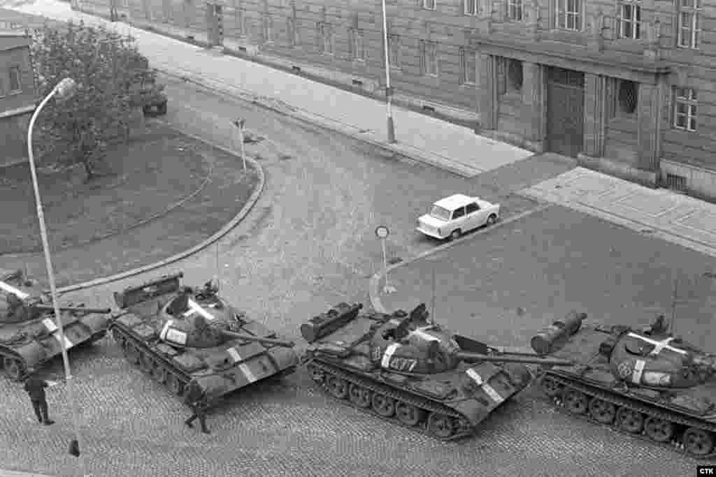 Invading Soviet tanks with white markings deploy near the Communist Party headquarters in Prague.