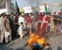 Pakistanis burn a Danish flag in protest at the publication of a series of cartoons in the Danish paper \