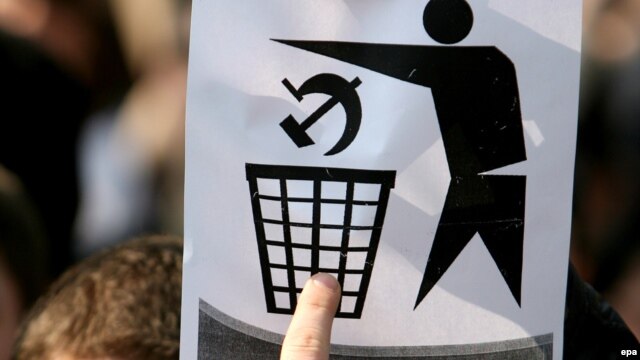 A student holds up a sign during an anticommunist demonstration in Chisinau in 2009.