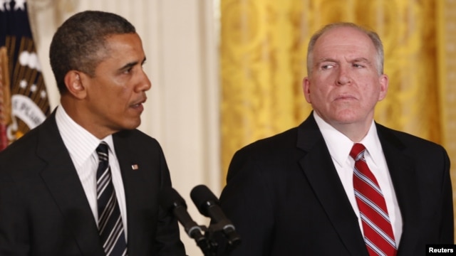 White House counterterrorism adviser John Brennan (right) listens as U.S. President Barack Obama nominates him to become the next CIA director at the White House in Washington on January 7. 