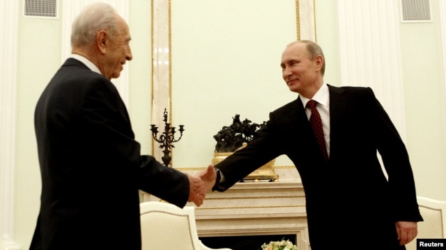 Russian President Vladimir Putin (right) greets Shimon Peres at the Kremlin in Moscow.