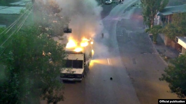 Armenia - A police vehicle which the Armenia police say was set on fire by opposition gunmen, 25Jul2016.