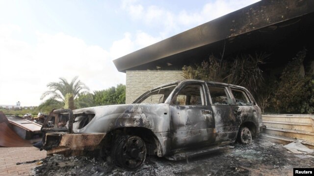 A burned-out car outside the destroyed U.S. Consulate in Benghazi