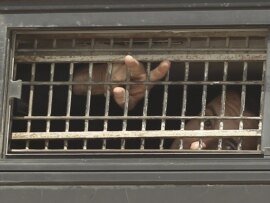 A Palestinian prisoner gestures from the window of a bus as it leaves Nafha Prison in the southern town of Mitzpe Ramon on October 16.