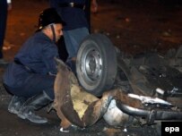 Security officer examines a blast site on a highway near the airport in Mumbai
