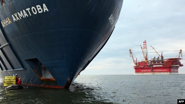 Greenpeace activists attach themselves to the anchor of the Anna Akhmatova, a Russian Arctic rig support vessel.