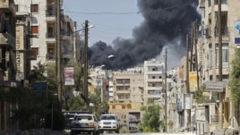 Syria -- Smoke rises after a Syrian Air Force fighter jet launched missiles at El Edaa district in northwestern city of Aleppo, 05Sep2012