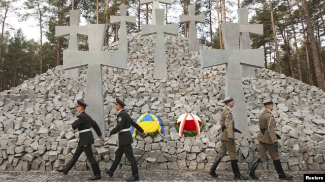 Polish and Ukrainian soldiers march during a commemoration ceremony for the victims of Soviet-era repressions at the memorial near the village of Bykivnia, outside Kyiv, on September 21.