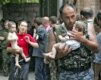 A soldier carries a baby who was among a small group of hostages released on September 2, 2004 (epa)