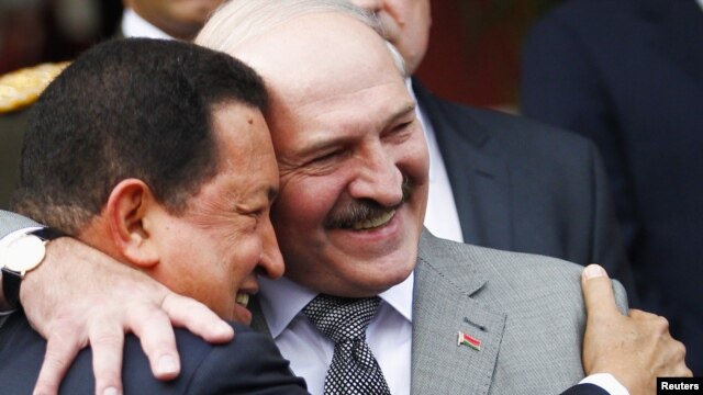 Venezuelan President Hugo Chavez (left) and his Belarusian counterpart, Alyaksandr Lukashenka, embrace at Miraflores Palace in Caracas.