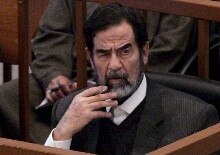 Iraq -- Saddam Hussein listens to the one of the prosecutors as his trial resumes in Baghdad, 28 Feb. 2006