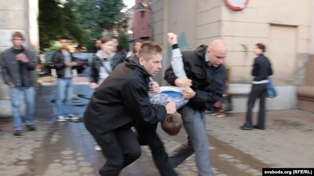 Plainclothes police officers arrest a protester in Minsk on July 3.