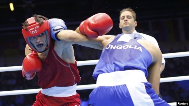 Azerbaijan's Elvin Mamishzada (left) boxes Mongolia's Tugstsogt Nyambayar in London. No word yet from Azerbaijan if anyone was watching.