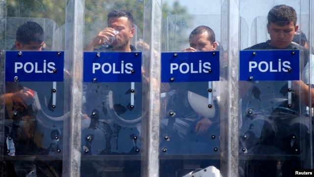 Police guard the entrance of Gezi Park on Taksim Square in Istanbul on June 17. 