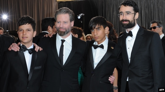 Actors Fawad Mohammadi (second from right) and Jawanmard Paiz (left) arrive with director Sam French (second from left) and producer Ariel Nasr on the red carpet for the 85th annual Academy Awards.