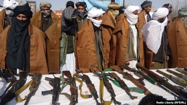 A group of 20 Taliban militants in Afghanistan's Herat Province give up their weapons on February 20.
