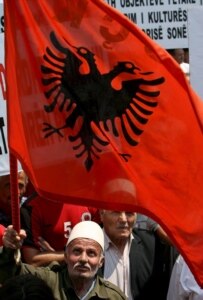 An ethnic Albanian man holds the flag of Albania during a July 24 rally in the capital of Kosovo, Prishtina (epa)