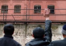 Georgia – Prisoners waving at their relatives outside Tbilisi prison where a riot broke early Monday morning, March 27, 2006