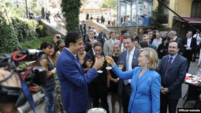 Georgian President Mikheil Saakashvili and U.S. Secretary of State Hillary Clinton toast good relations in Tbilisi in July.
