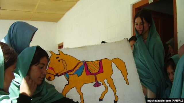 Students at CAI's Immit Higher Secondary School pose with some of their school work in April 2011.