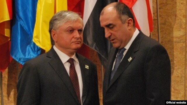 Armenia's Edward Nalbandian and Azerbaijan's Elmar Mammadyarov meet on the sidelines of a NATO summit in Lisbon in November 2010.