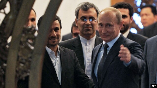 Russian President Vladimir Putin (right) gestures as he speaks with his Iranian counterpart Mahmud Ahmadinejad (left) during a meeting in Beijing in June 2012.