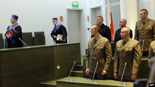 Polish soldiers stand in Poland's top court in Warsaw as they await a judgment on allegations of war crimes in Afghanistan. 