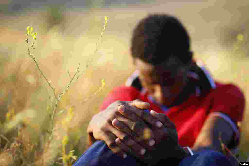 A migrant, who said he was from Somalia, sits on the ground after being apprehended near the town of Presevo.