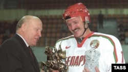 Lukashenka receives a trophy after a more successful match.