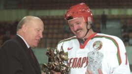 Lukashenka receives a trophy after a more successful match.