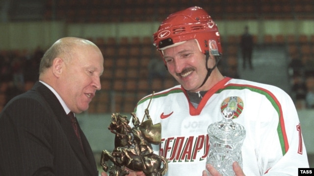 Lukashenka receives a trophy after a more successful match.