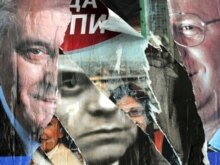 Serbia -  A rided pre-election poster of V. Seselj (R) currently on trial in The Hague for war crimes, leader of the Serbian Radical Party, and his deputy T. Nikolic (L) and Serbian Prime Minister V. Kostunica (C) in Belgrade, 09May2008