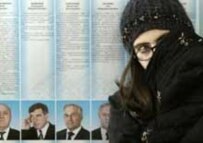 A girl waits for her mother at a polling station in Grozny on 27 November (AFP)