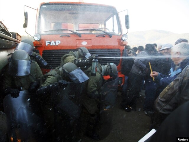 Kosovo Force (KFOR) troops employ tear gas against protesters trying to prevent the barricades from being dismantled in Jagnjenica near Zubin Potok on October 20.