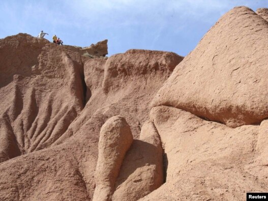 Tourists take in the view in the Canyon of Wonders near the town of Tamga close to Kyrgyzstan's Lake Issyk-Kul.