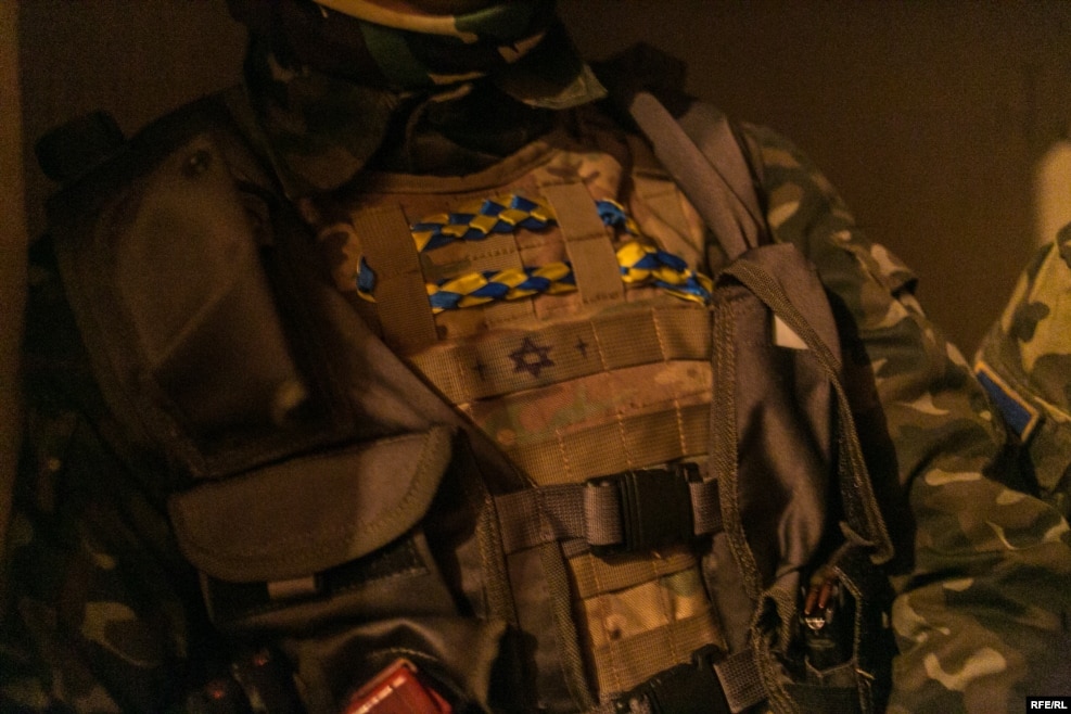 A soldier wears a bulletproof vest with a Star of David drawn on the front. Although the soldiers in this battalion are nationalists, they fight alongside a unit of Jewish volunteer soldiers, who also declare themselves to be Ukrainian nationalists.