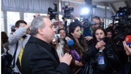 Armenia - Opposition presidential candidate Hrant Bagratian votes talks to reporters at a polling station in Yerevan, 18Feb2013.