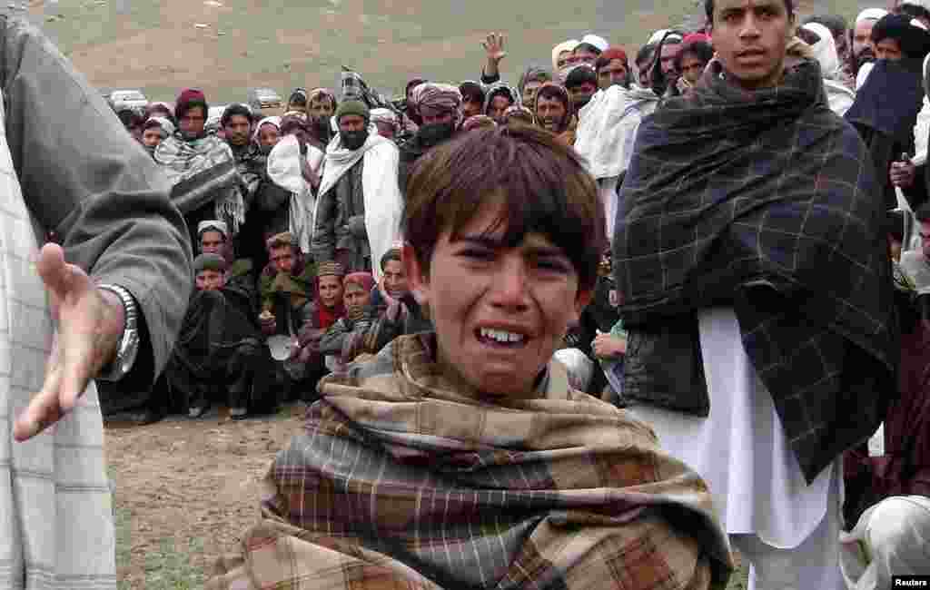 A boy cries during a funeral of members of his family in Afghanistan's Logar Province. (Reuters)