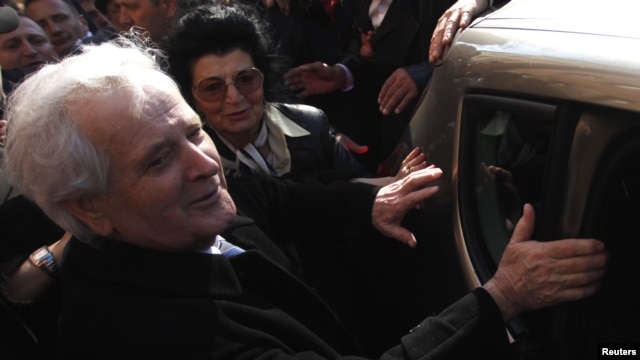 Former Bosnian Muslim warlord Fikret Abdic and his wife get into a car in front of the prison in Pula, where several thousand supporters greeted him after his release on March 9.