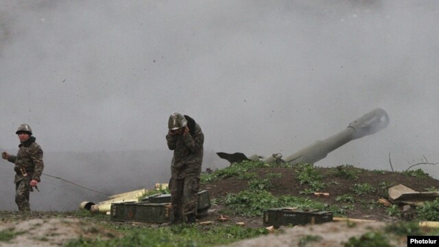 Karabakh Armenian troops fire rounds from a howitzer in the Martakert district of the breakaway rgion in early April.