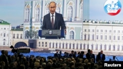 Russian President Vladimir Putin is seen on a giant screen at the St. Petersburg International Economic Forum 2015 (SPIEF 2015) on June 19.