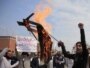Pakistan - A student holds a burning effigy depicting U.S. special forces officer Raymond Davis while shouting slogans during a protest in Peshawar, 24Feb2011