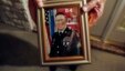 Wilburn Russell, 73, displays a portrait of his son, John M. Russell, the Army sergeant who was convicted of killing five fellow soldiers.