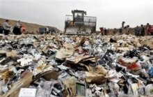 Russia -- A giant bulldozer smashes pirated software and music DVD's and CDs, Moscow, 31 May 2005