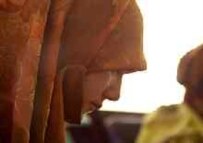 A Tajik woman in an Islamic head scarf, now banned from schools (official website)