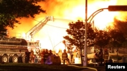 First responders at the scene of the blaze after a train derailment and explosion in Lac-Megantic, Quebec early on July 6 that killed at least 50 people.