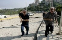 Lebanese soldiers and civilians run for cover during an Israeli air strike in Beirut (epa)