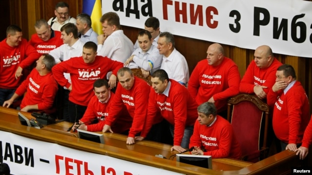 Deputies representing the Udar party led by Vitali Klitschko block the speaker's rostrum during a session of parliament in Kyiv on February 5.