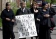 Beslan relatives demonstrate outside the Kulayev trial in May 2006, holding anti-Putin placards (epa)